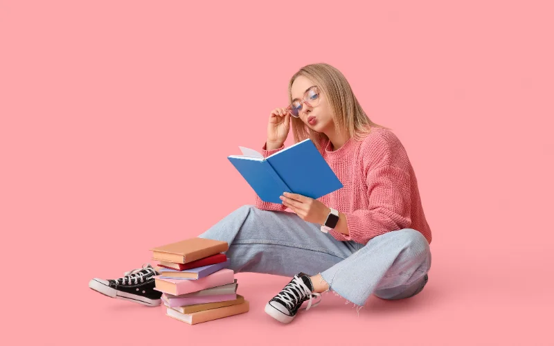 a girl reading many books