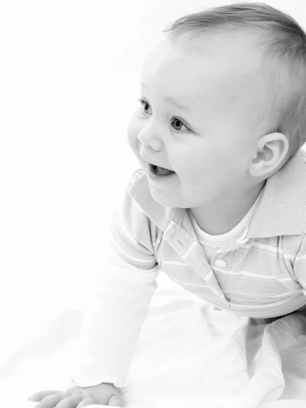 a baby laughing while crawling