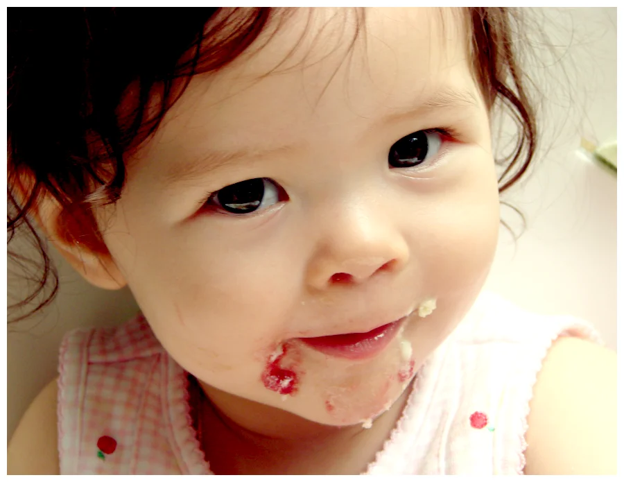 baby girl with cake on her face