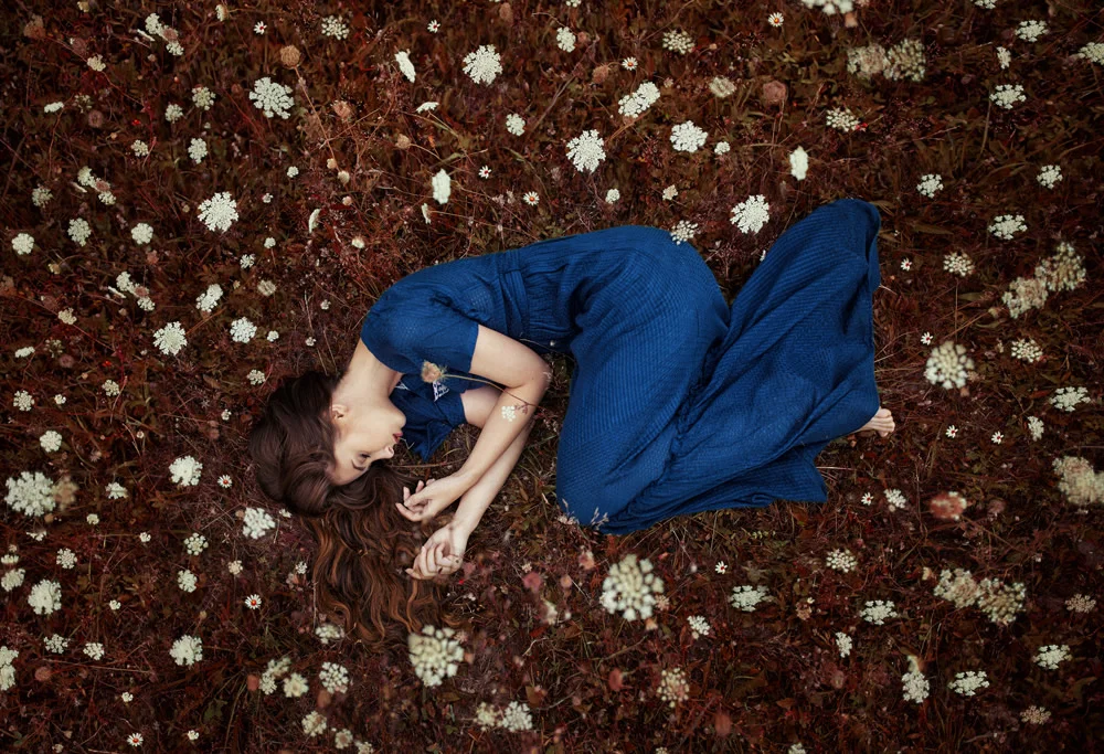 Woman lying on the forest floor