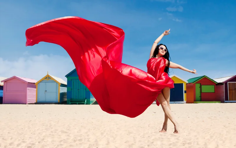 woman posing in a gown on the shore