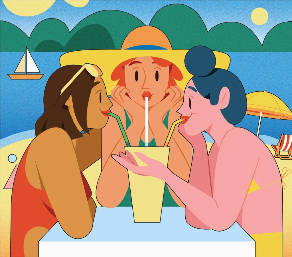 2 girls having a summer drink on a beach